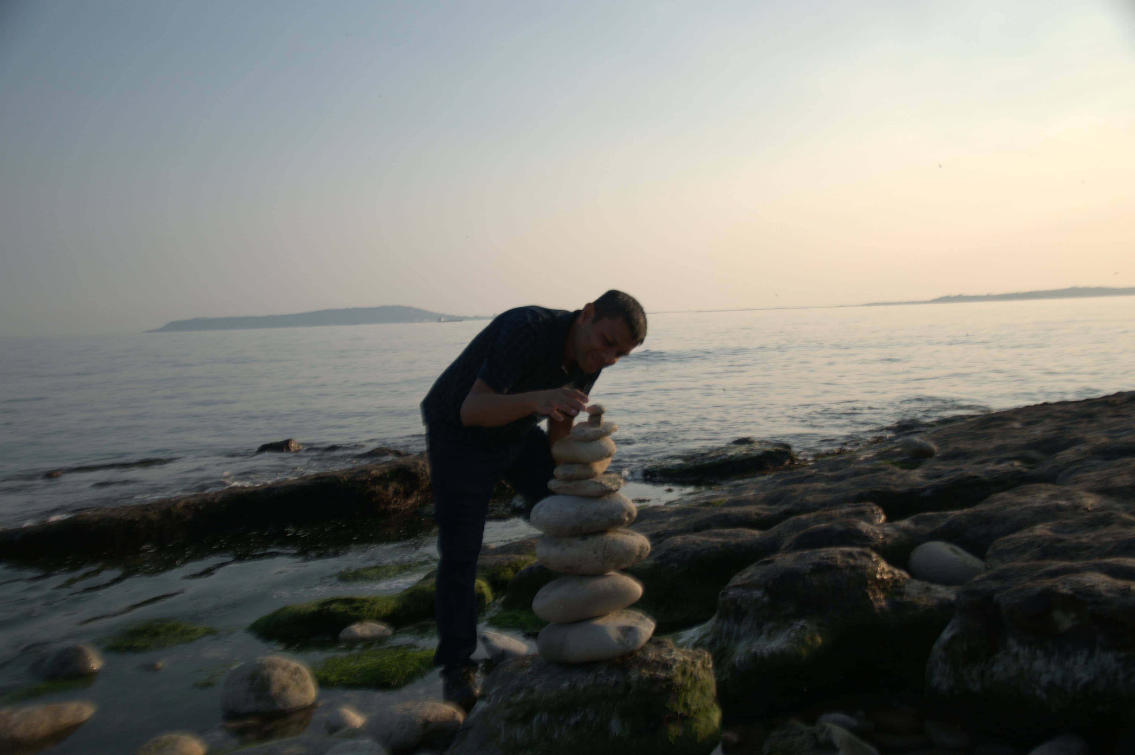 Rock balancing by the sea — finding balance and harmony